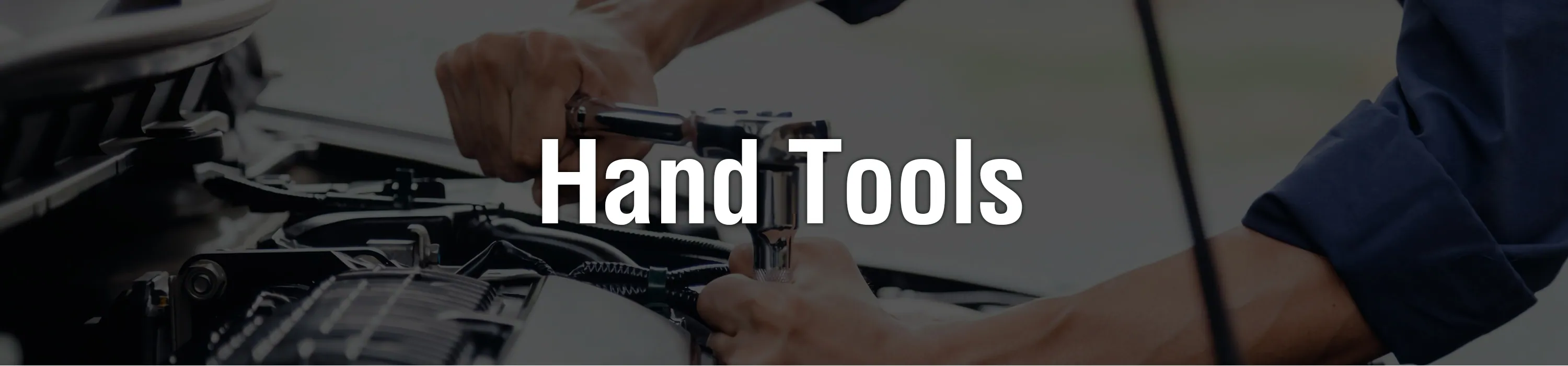 Hands working with tools at a bench: our hand tool range