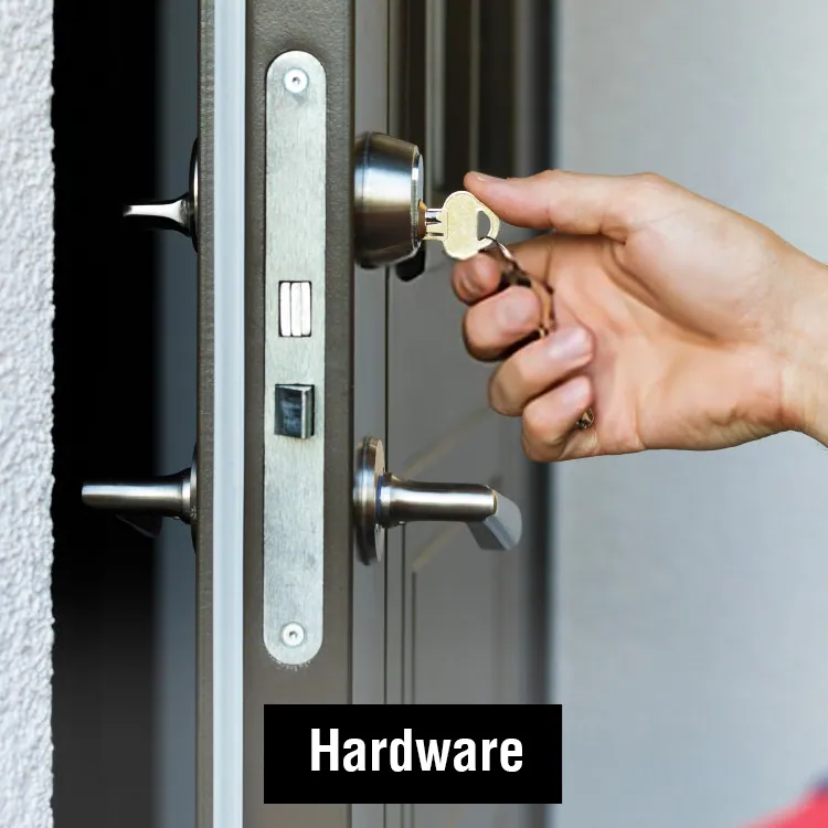 A hand turning a key in a door lock: our hardware range